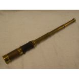 An old brass three-draw telescope with leather clad body