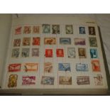 An old album containing a selection of various World stamps