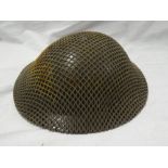 A British steel helmet dated 1938 with net cover