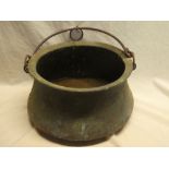 A 19th Century copper circular cauldron with iron swing handle,