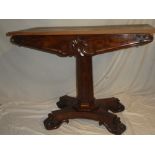 A Victorian carved mahogany table base with tapered column and plateau base with replacement top