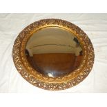 A good quality convex circular wall mirror in gilt painted frame 25" diameter
