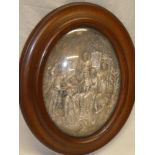 A Continental plaster oval relief decorated plaque depicting a religious scene with numerous