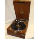 An HMV portable gramophone with chromium-plated mounts in brown snakeskin-effect case