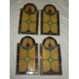Four leaded stained glass arched window panels,