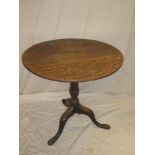 A 19th century oak circular snap-top table with turned column and tripod base