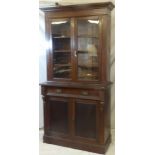 A late Victorian mahogany bookcase with a single drawer in the frieze and cupboard enclosed by two