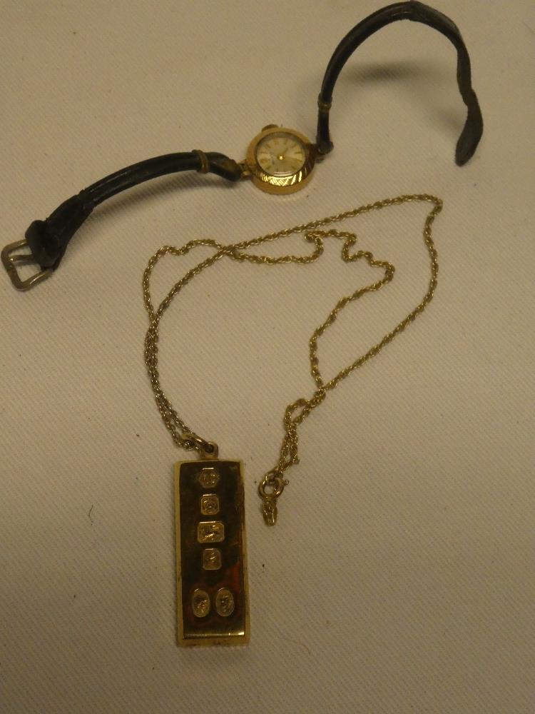 A ladies 9ct gold wristwatch by Helvetia and a silver ingot pendant with chain