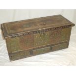 An old Indian wooden rectangular trunk decorated with brass strips and brass headed nails with