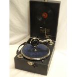 A small Broadcast Super portable gramophone with chromium-plated mounts and internal records in