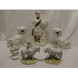 A pair of Victorian Staffordshire pottery figures of young girls seated on ponies,