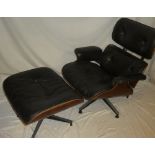 A 1960's rosewood easy chair by Eames upholstered in black buttoned leather together with matching