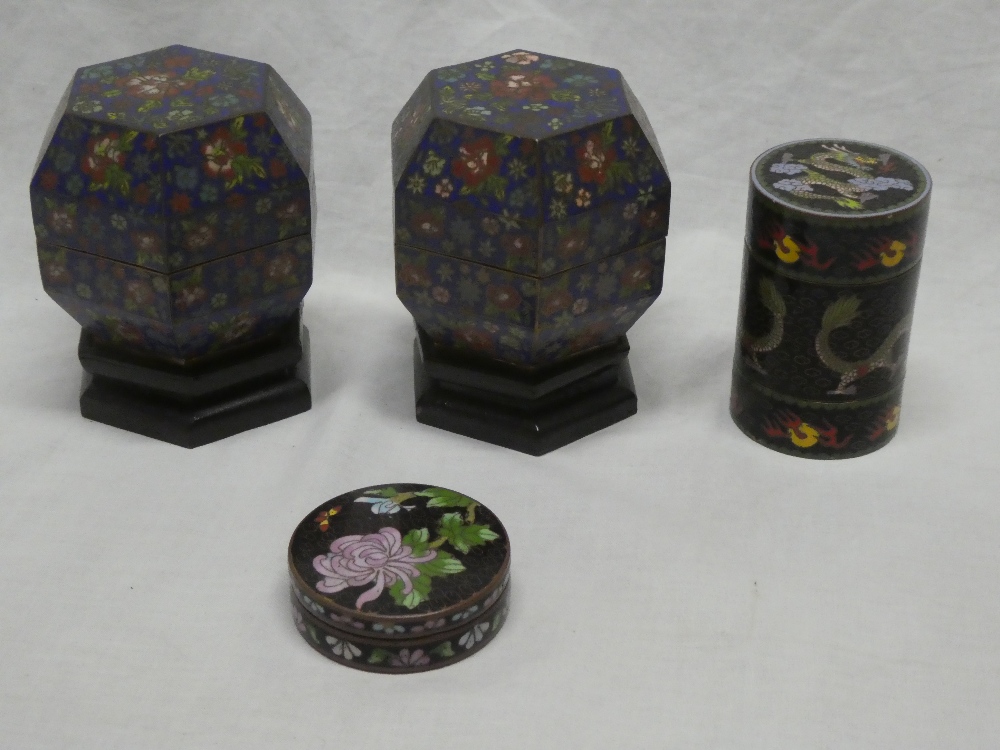 A pair of Eastern cloisonne enamelled hexagonal jars and covers with floral decoration on blue