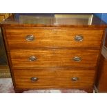 A 19th century mahogany chest of three long drawers with brass ring handles on bracket feet