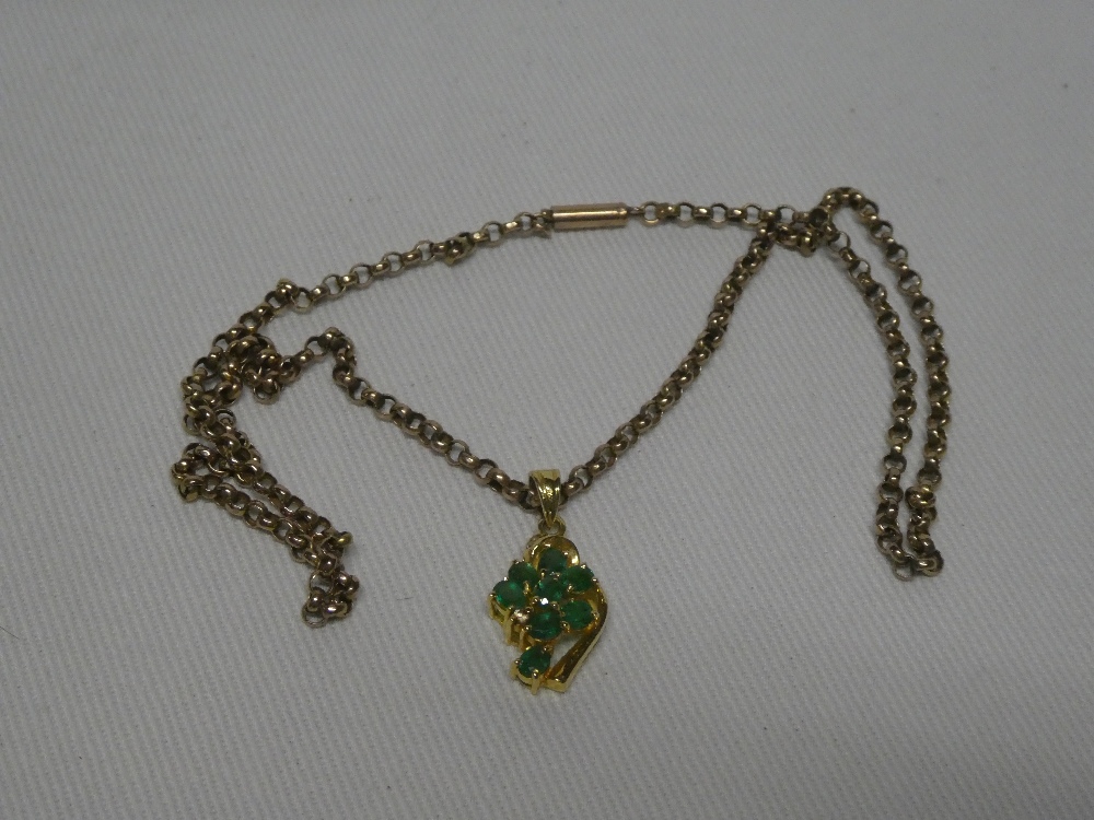 A 15ct gold pendant inset with green stones and diamond chips together with 9ct gold chain