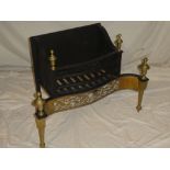 A good quality Georgian-style brass mounted iron fire grate with brass pierced apron and finials,