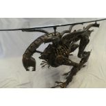 An unusual constructed scrap metal coffee table based on the 1979 film Alien with oval plate glass