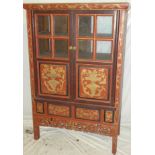 An old Chinese painted wood two-door side cabinet with shelves enclosed by glazed and decorated