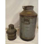 An old brass mounted iron two-handled milk churn 26" high and one other similar smaller hand churn
