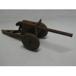 An old painted tin-plate model artillery gun,
