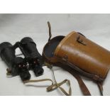 A pair of military 7x50 binoculars in leather carrying case