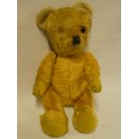 An old plush covered teddy bear,