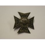 An Officer's blackened white metal cap badge of the 6th battalion East Surrey Regiment