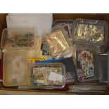 A box containing numerous packets and boxes of GB and World stamps,