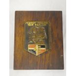 A painted brass shield plaque for the French 46th Infantry "Plutot Mourir que Faillir" on wooden