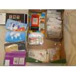 A box containing various packets of World stamps, Guernsey and Jersey mint stamp booklets,