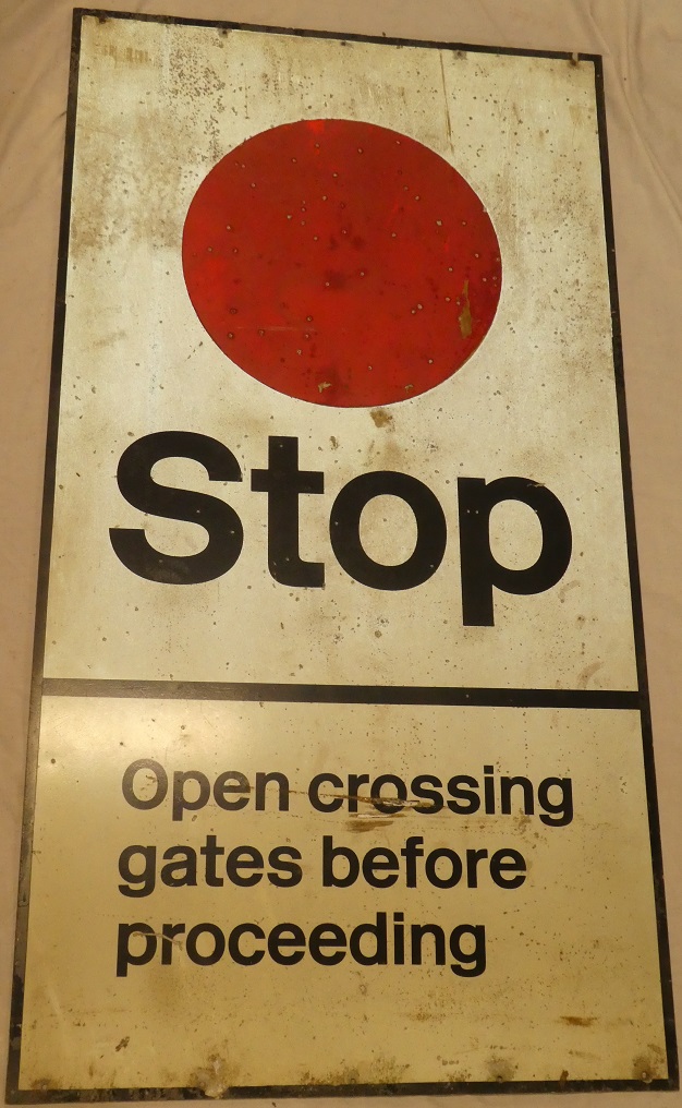 An aluminium rectangular railways level crossing sign "STOP Open Crossing Gates Before Proceeding"