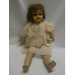 An old composition child's doll with sleeping eyes and jointed body