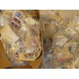 A large box containing numerous packets of World stamps