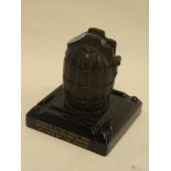 An inert First War hand grenade adapted as an inkwell dated 1915 with enamelled presentation top