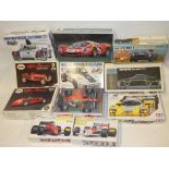 A selection of boxed unmade vehicle kits including Tamiya Porsche 936, Tamiya Ferrari F189,