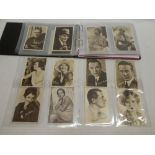 An album containing a set of 25 Sarony cinema stars large sized cigarette cards/postcards;