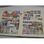 A large stock book containing a selection of unmounted mint GB commemorative stamps,