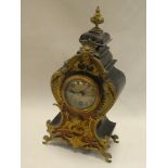 A 19th century French mantel clock with decorated circular dial in brass mounted walnut and