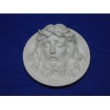 A 19th century Parian china circular wall plaque depicting the head of Christ 8" diameter