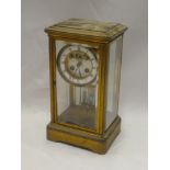 A good quality brass four-glass mantel clock with enamelled circular dial and mercury pendulum in