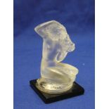 A small Lalique glass figure of a crouching nude female on black glass square base 3½" high
