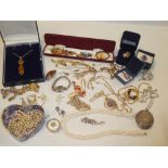 A selection of various costume jewellery including silver oval pendant locket necklace,