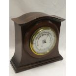 A good quality aneroid barometer with circular dial in arched mahogany case 14½" high