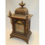 A German bracket clock with gilt and silvered arched dial in brass mounted stained wood tapered