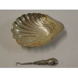 A silver scallop-shaped sweet meat dish,