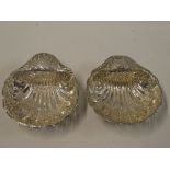 A pair of Edward VII silver scallop-shaped sweetmeat dishes with raised and pierced decoration,