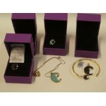 Five pieces of 10ct gold moon decorated jewellery including 10ct gold bangle mounted with black