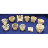 Eleven various white glazed lattice work basket planters including several 19th century examples