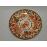 A 19th century Japanese Kutani pottery circular plate with painted immortal figure decoration on