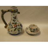 A Continental pottery tapered jug with rustic handle and floral decoration 8" high and a